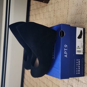 Women's black suede wedge heels.